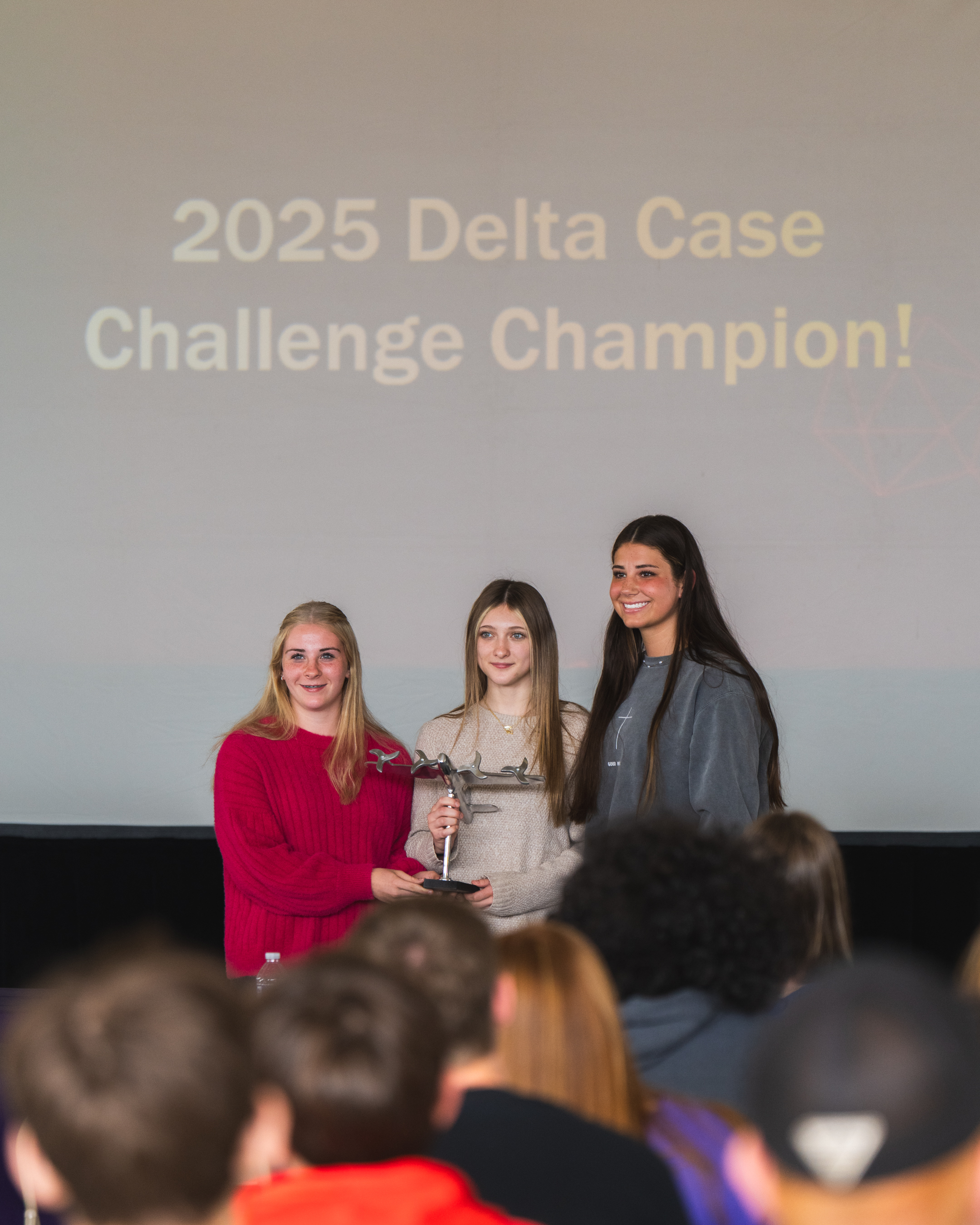 three students receiving award
